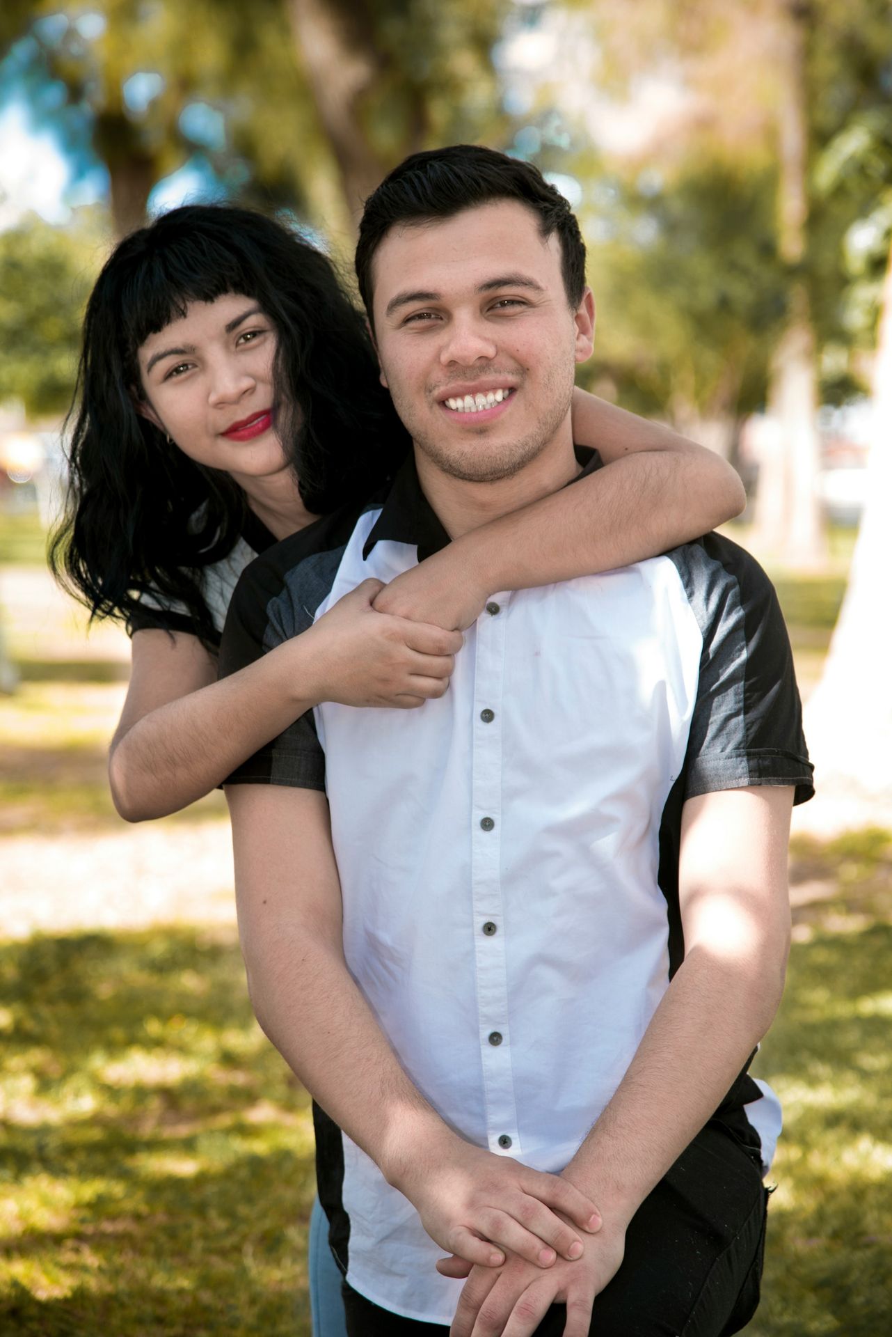 a man holding a woman in a park